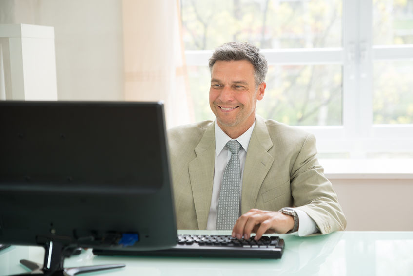 Happy man in suit in his office